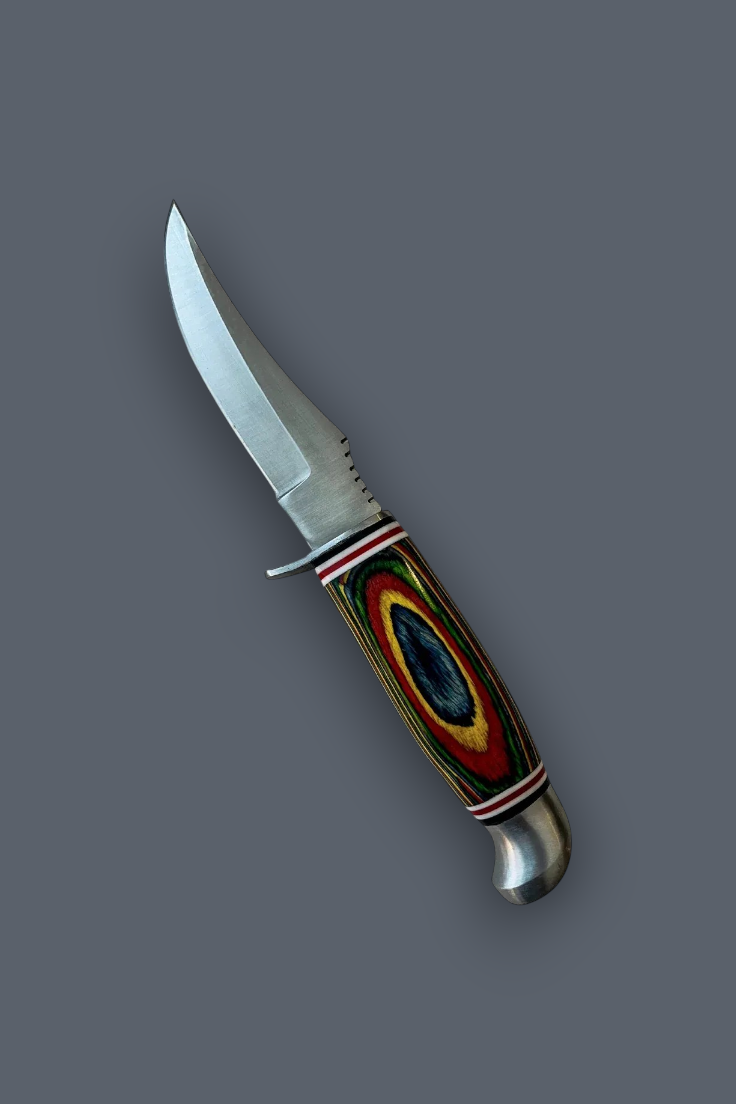 A fixed-blade knife with a curved silver steel blade and a colorful handle featuring a circular pattern of red, yellow, green, and black, set against a solid dark gray background.