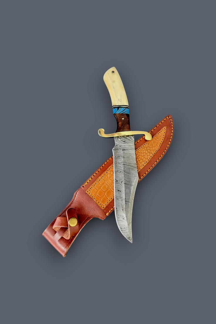A fixed-blade knife with a patterned steel blade, cream-colored bone handle, and blue wrap accent, displayed diagonally over its brown leather sheath on a solid dark gray background.