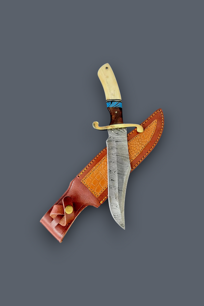 A fixed-blade knife with a patterned steel blade, cream-colored bone handle, and blue wrap accent, displayed diagonally over its brown leather sheath on a solid dark gray background.