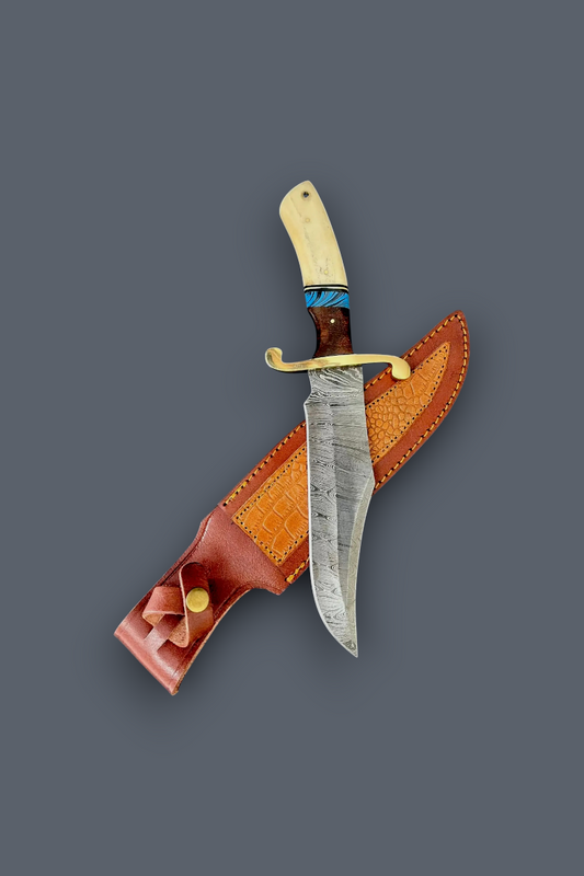 A fixed-blade knife with a patterned steel blade, cream-colored bone handle, and blue wrap accent, displayed diagonally over its brown leather sheath on a solid dark gray background.