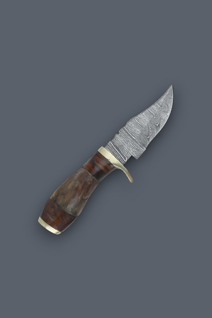 A fixed-blade knife with a patterned Damascus steel blade, a curved brown wooden handle, and brass bolsters, shown on a solid dark gray background.