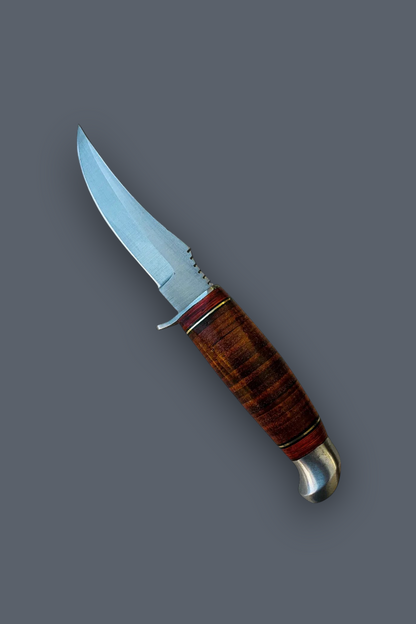 A fixed-blade knife with a curved silver steel blade and a polished reddish-brown wooden handle with a silver bolster, shown diagonally on a solid dark gray background.