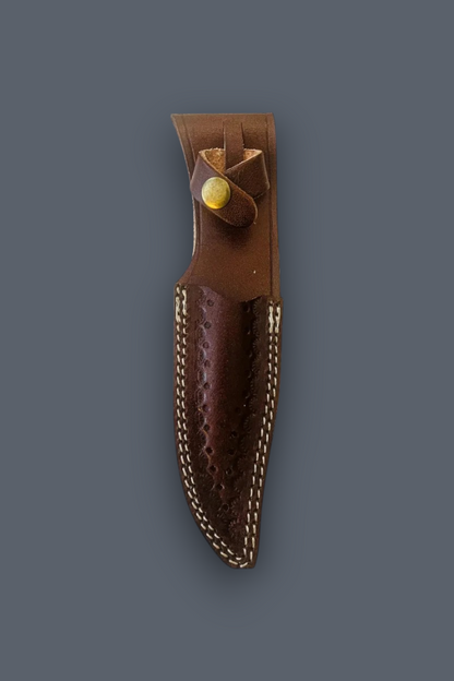 A brown leather knife sheath with a textured pattern, contrast stitching, and a brass rivet, shown against a solid dark gray background.