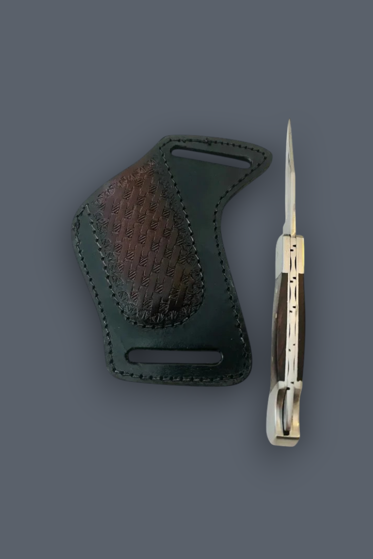 A dark green leather knife sheath with a textured brown grip panel, shown next to a folding pocket knife with a silver blade and dark handle, on a solid dark gray background.
