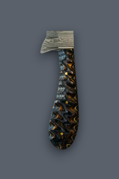 A decorative dagger or letter opener with a textured, patterned handle in black, gold, and blue, and a silver-gray patterned blade, shown against a solid dark gray background.