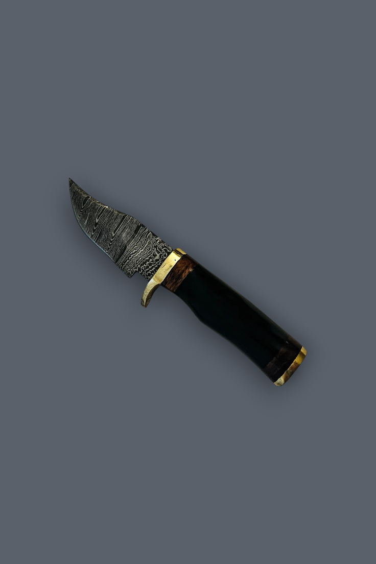 A fixed-blade knife with a textured, patterned steel blade, a polished brass guard, and a black handle with gold accents, shown on a solid dark gray background.