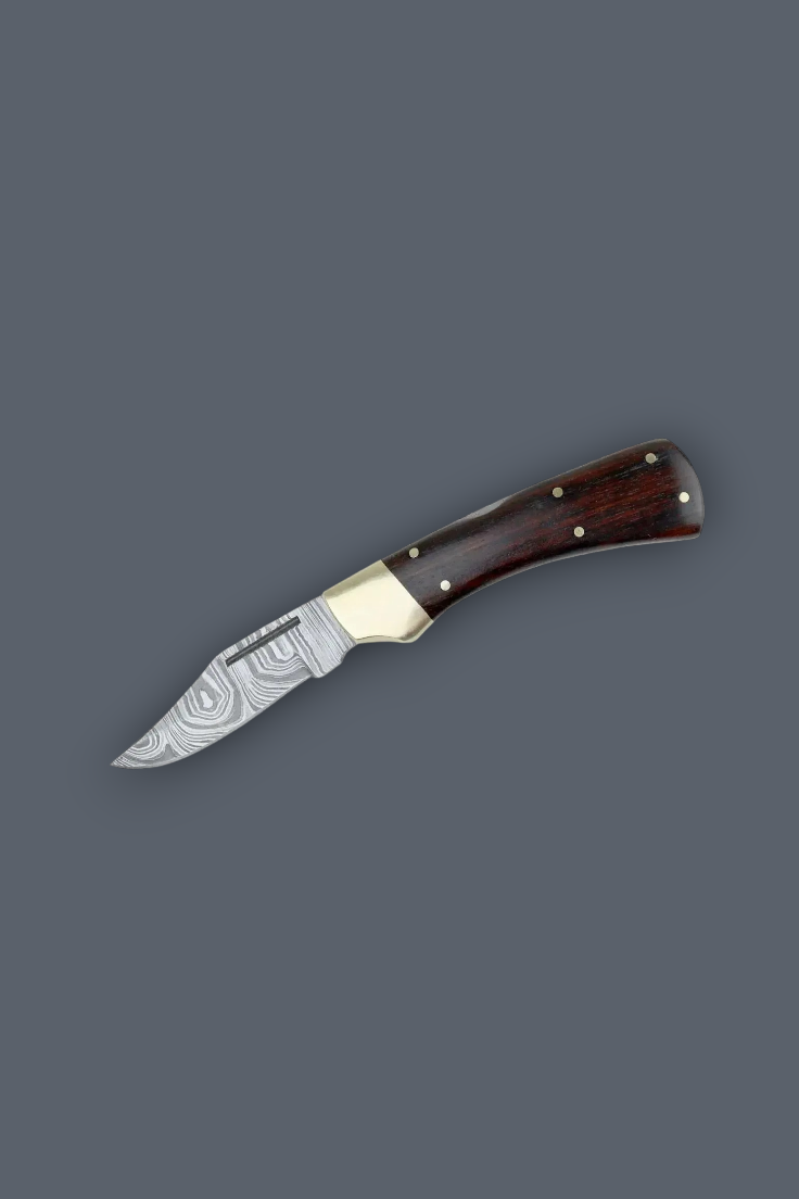 A pocket knife with a Damascus steel blade and a dark reddish-brown wooden handle with brass bolsters, shown on a solid dark gray background.