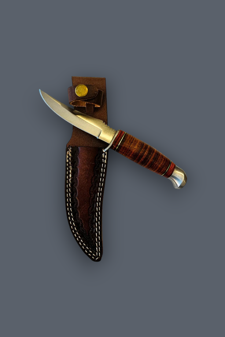 A fixed-blade knife with a silver blade, brass bolster, and striped brown wooden handle, shown partially inserted into a brown leather sheath with white stitching against a solid dark gray background.