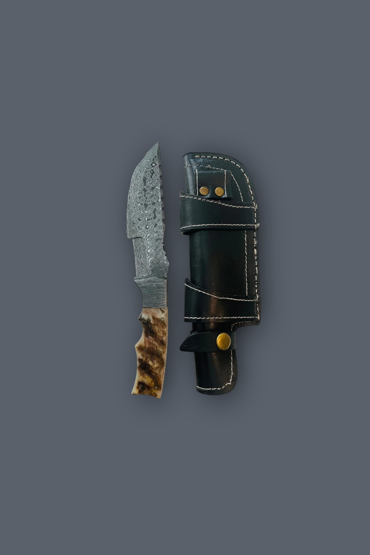 A fixed-blade knife with a patterned steel blade, a brown and black textured handle, and a black leather sheath with gold-toned hardware, displayed on a solid dark gray background.