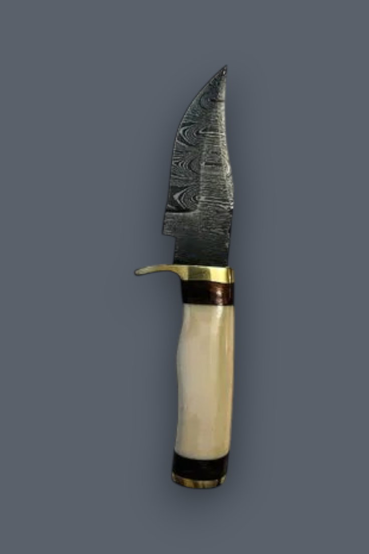 A fixed-blade knife with a patterned Damascus steel blade, a brass guard and pommel, and a curved cream-colored bone handle with dark brown and black inlay bands, shown against a solid dark gray background.