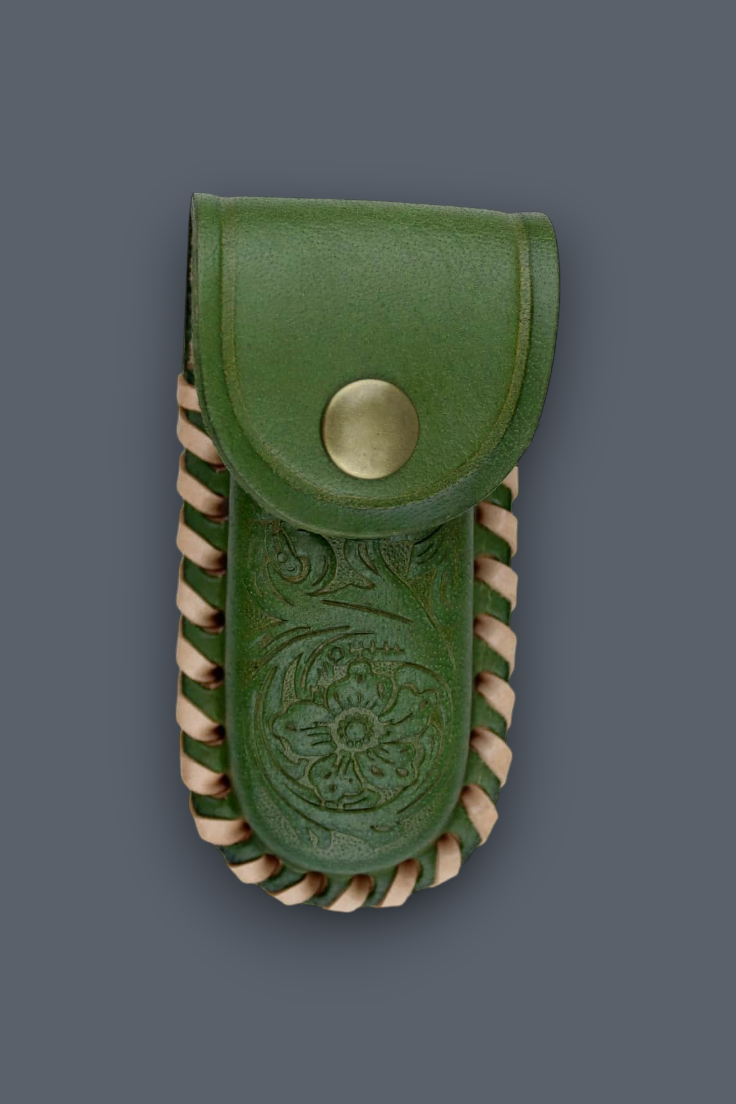 An olive green leather pouch with a snap button closure, featuring an embossed floral design on the front and twisted tan leather trim along the edges, set against a solid dark gray background.