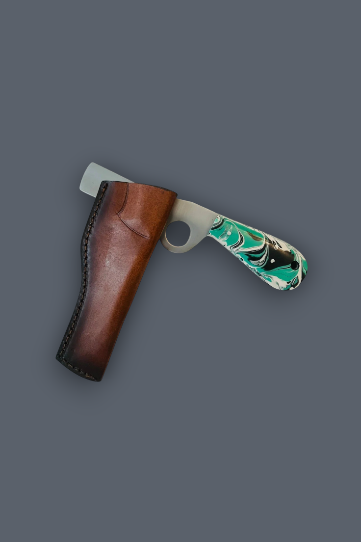 A fixed-blade knife with a green and black marbled handle, partially tucked into a brown leather sheath, set against a solid dark gray background.