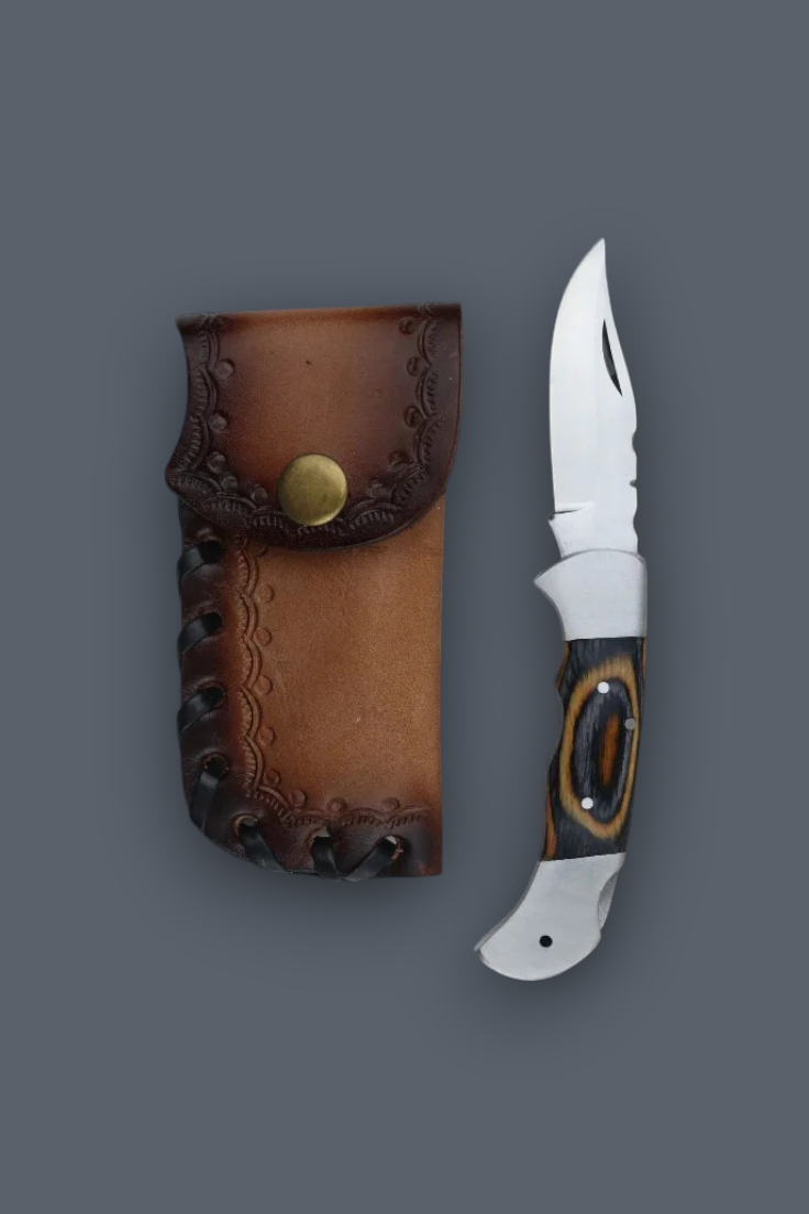 A folding pocket knife with a silver blade and patterned handle, displayed next to its brown leather sheath on a solid dark gray background.