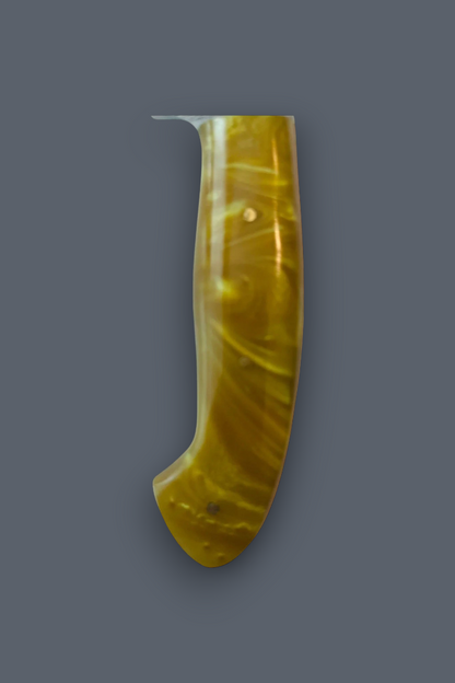 A single curved amber-yellow translucent object with a glossy finish, shown upright against a plain dark gray background.