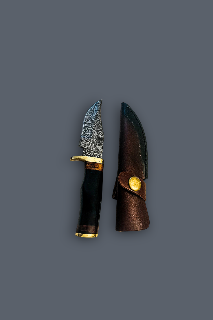A fixed-blade knife with a patterned steel blade, black handle, and gold-toned bolster, shown next to its brown leather sheath on a solid dark gray background.