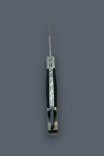 A folding pocket knife with a black handle and silver metal components, shown partially open against a solid dark gray background.