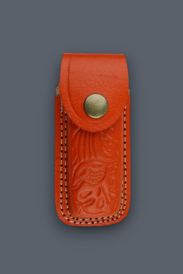 A small orange-red leather pouch with an embossed floral design, double-stitched edges, and a brass snap button, shown against a dark gray background.