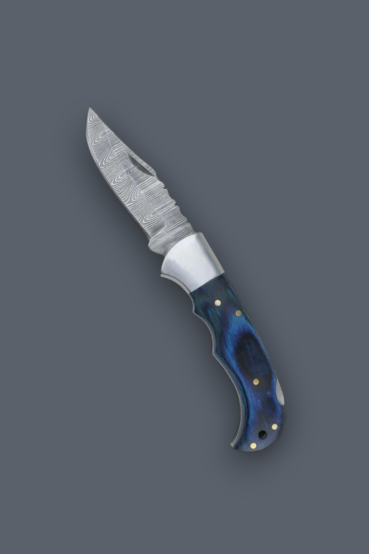 A fixed-blade knife with a patterned steel blade and a contoured handle featuring a blue and black marbled pattern with brass pins, shown on a solid dark gray background.