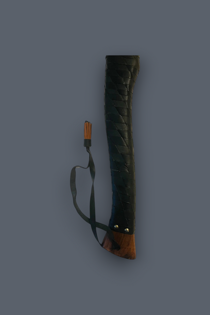 A dark leather-wrapped sword scabbard with a brown wooden handle and a black wrist strap, shown vertically against a solid dark gray background.