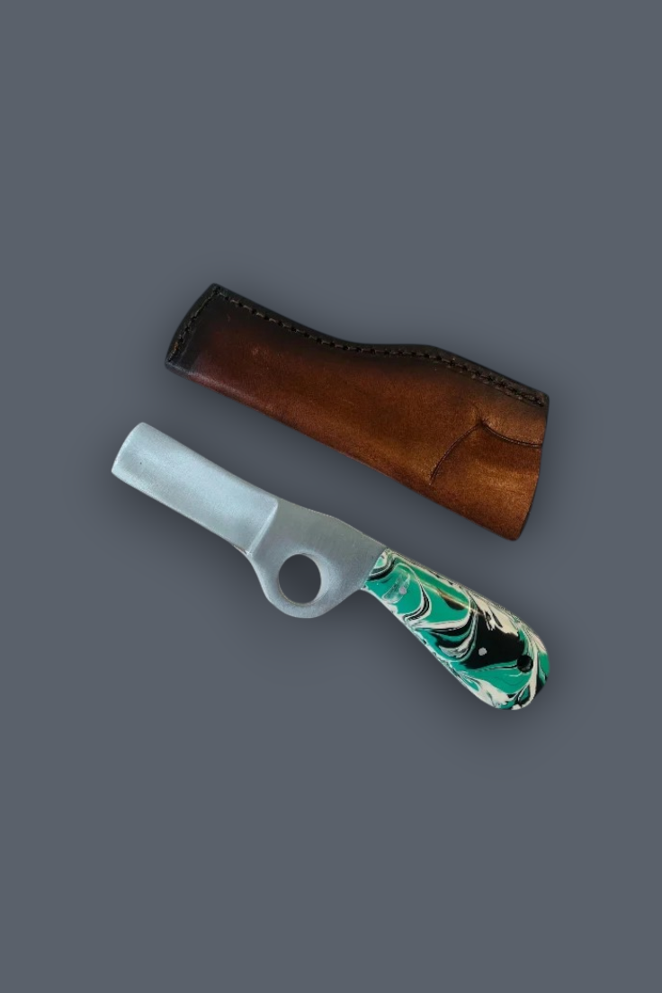A glass smoking pipe with a green, black, and white marbled handle and a white bowl, shown next to its brown leather sheath on a solid gray background.