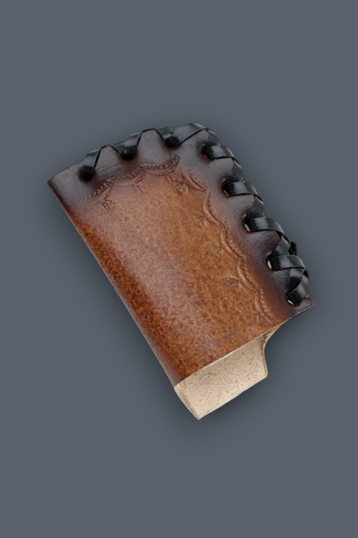 A brown leather knife sheath with decorative stitching and a light-colored wooden handle, shown on a solid dark gray background.