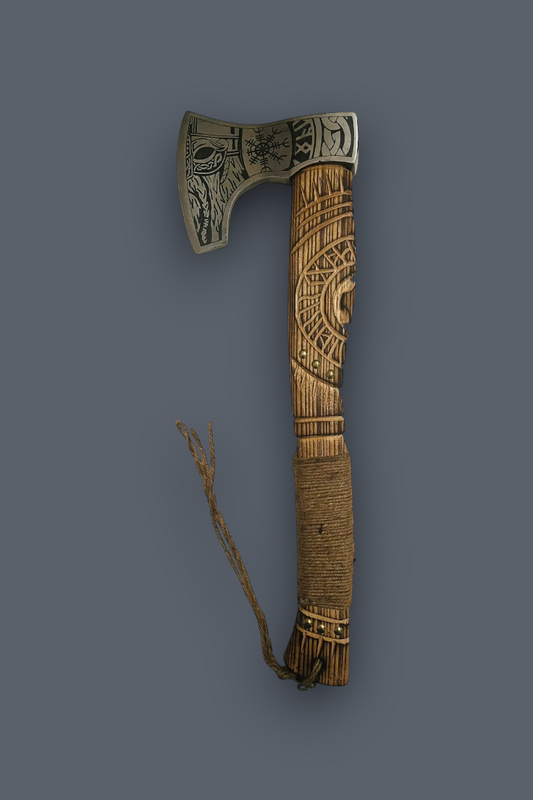 An ornate hand axe with a carved wooden handle, intricate metal head detailing, and a braided cord, shown against a solid dark gray background.