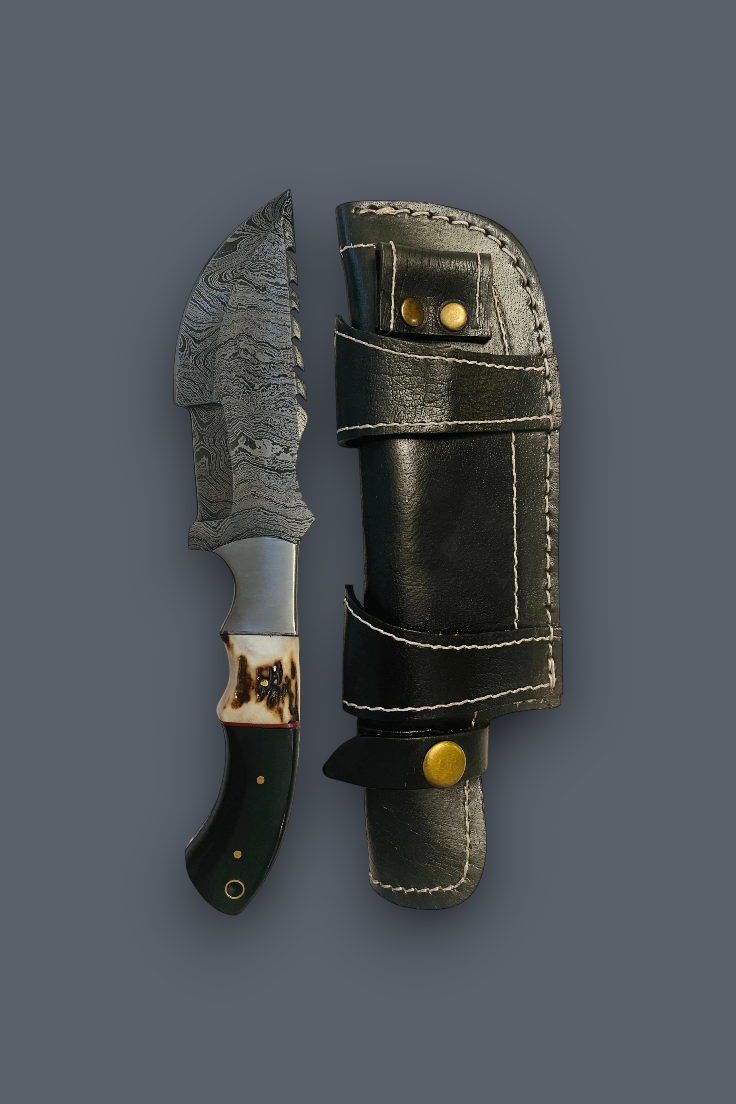 A fixed-blade knife with a patterned steel blade, dark handle, and decorative collar, shown next to its black leather sheath with brass snaps on a dark gray background.