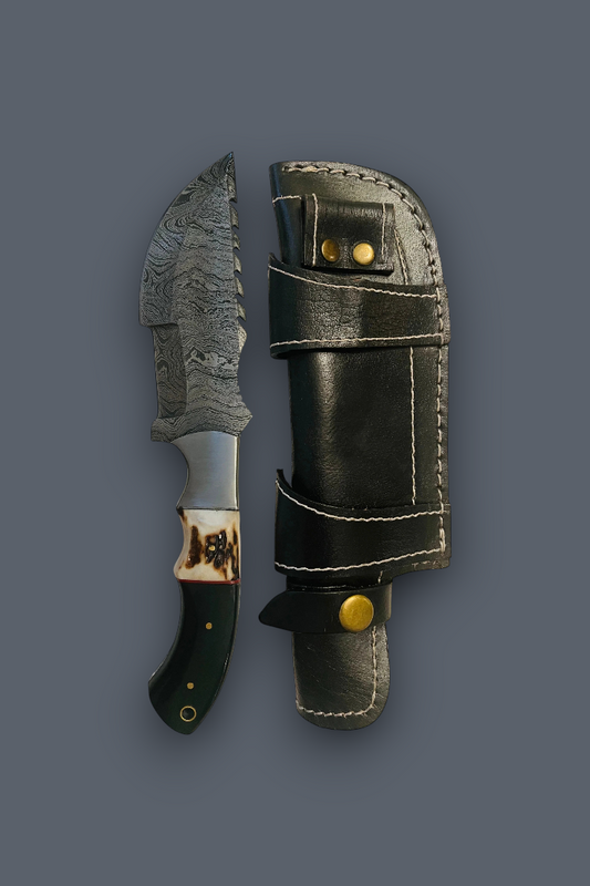 A fixed-blade knife with a patterned steel blade, dark handle, and decorative collar, shown next to its black leather sheath with brass snaps on a dark gray background.