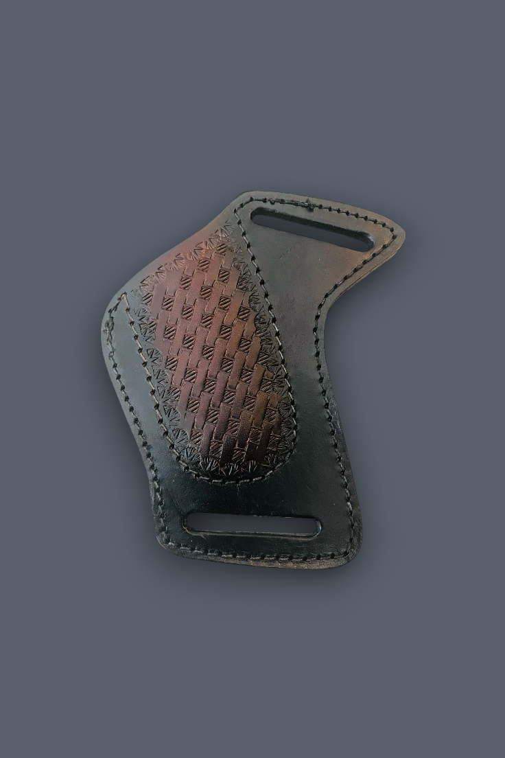 A dark brown leather belt buckle with a textured, embossed chevron pattern on one side and a smooth, polished metallic bronze finish on the other, shown on a solid dark gray background.