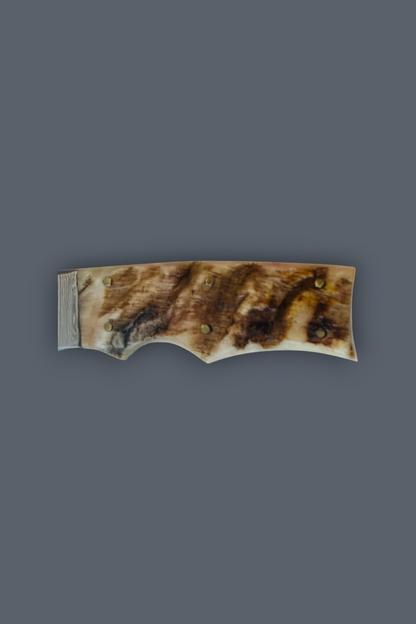 A single curved handle made of natural bone or horn with a marbled brown, beige, and cream pattern, photographed against a solid dark gray background.