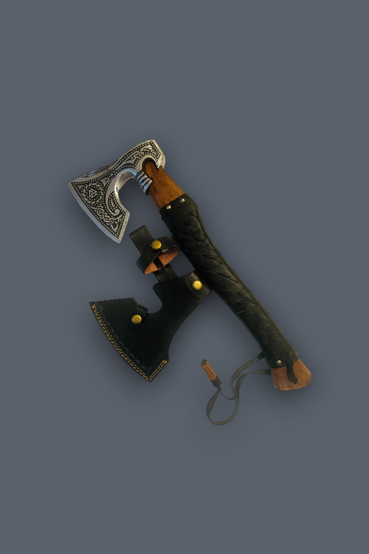 A decorative Viking-style axe with an ornate silver blade, a dark brown wooden handle, and a black leather sheath, displayed on a solid dark gray background.