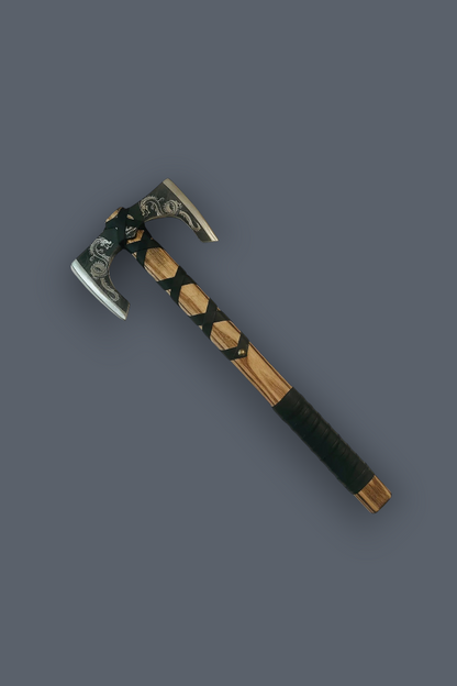 A decorative axe with a silver-toned metal head, black and brown wrapped handle, and black leather grip, shown diagonally on a solid dark gray background.
