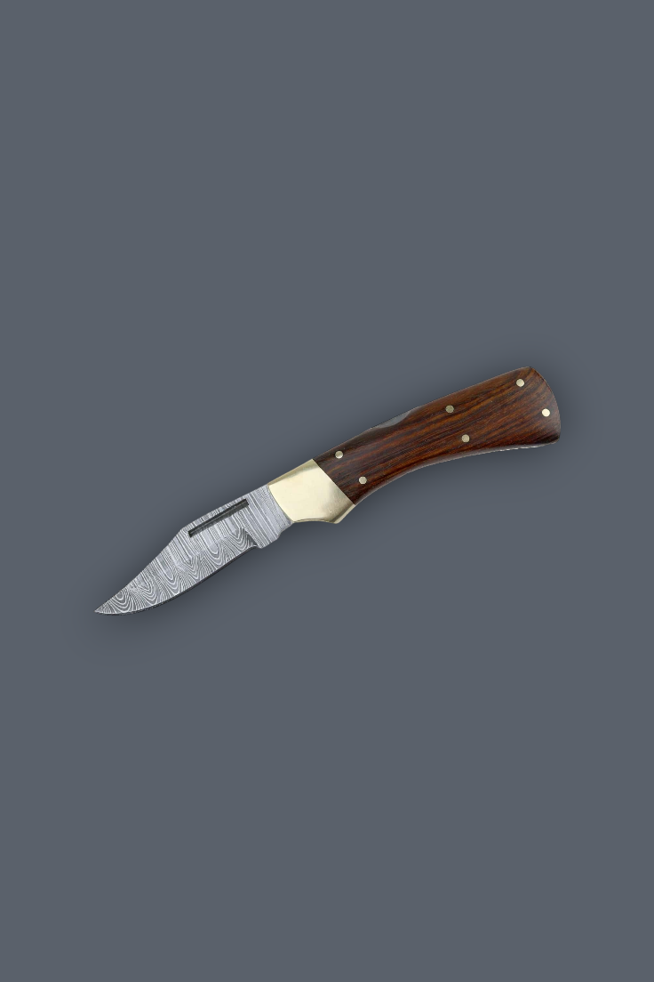 A small fixed-blade knife with a patterned steel blade, a brass bolster, and a dark brown wooden handle, shown diagonally on a solid dark gray background.