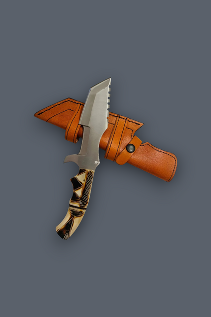 A fixed-blade knife with a silver blade and a black-and-cream patterned handle, shown partially inserted into an orange-brown leather sheath against a solid dark gray background.