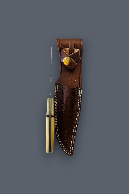 A vintage brass pocket knife with a silver blade and brass handle, displayed next to its dark brown leather sheath with white stitching and a brass snap button, set against a solid dark gray background.