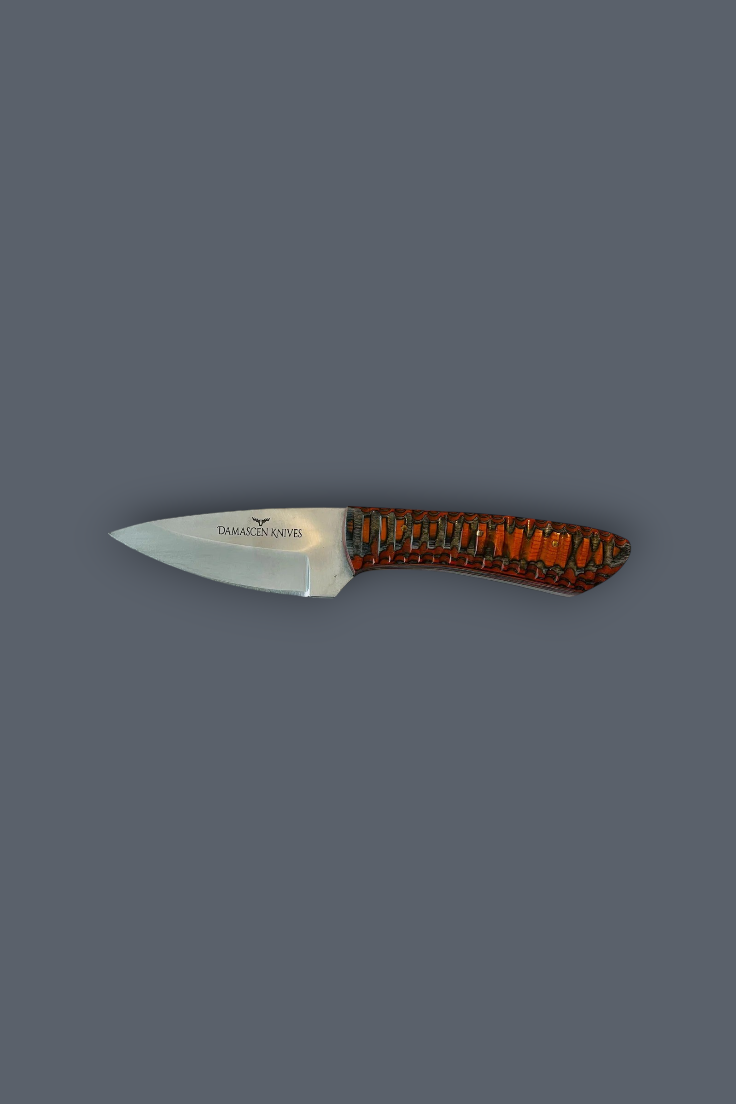 A small fixed-blade knife with a silver steel blade and a textured handle featuring a pattern of orange, brown, and black, shown against a solid dark gray background.