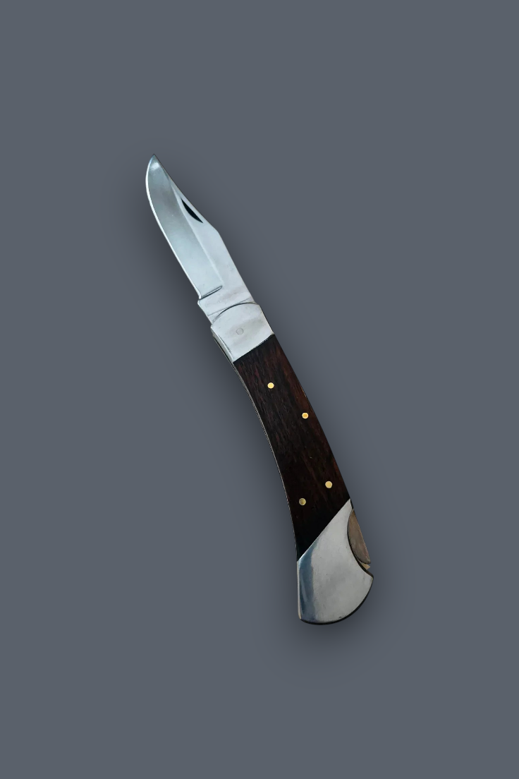 A folding pocket knife with a silver steel blade and a dark brown wooden handle accented by brass pins, shown diagonally on a solid dark gray background.