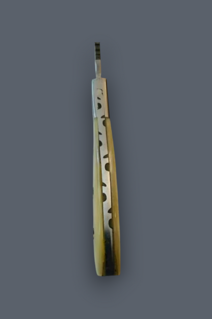 A vintage folding pocket knife with a carved bone handle and a silver metal blade, shown vertically against a solid dark gray background.