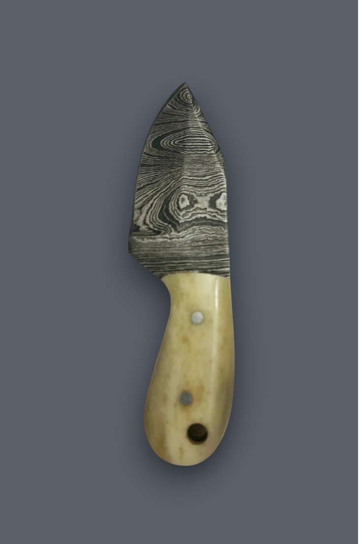 A small knife with a patterned Damascus steel blade and a light beige bone handle, shown vertically against a solid dark gray background.