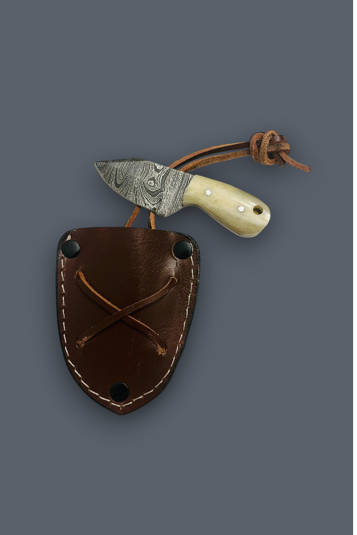 A fixed-blade knife with a patterned steel blade, cream bone handle, and brown leather sheath, displayed on a solid dark gray background.