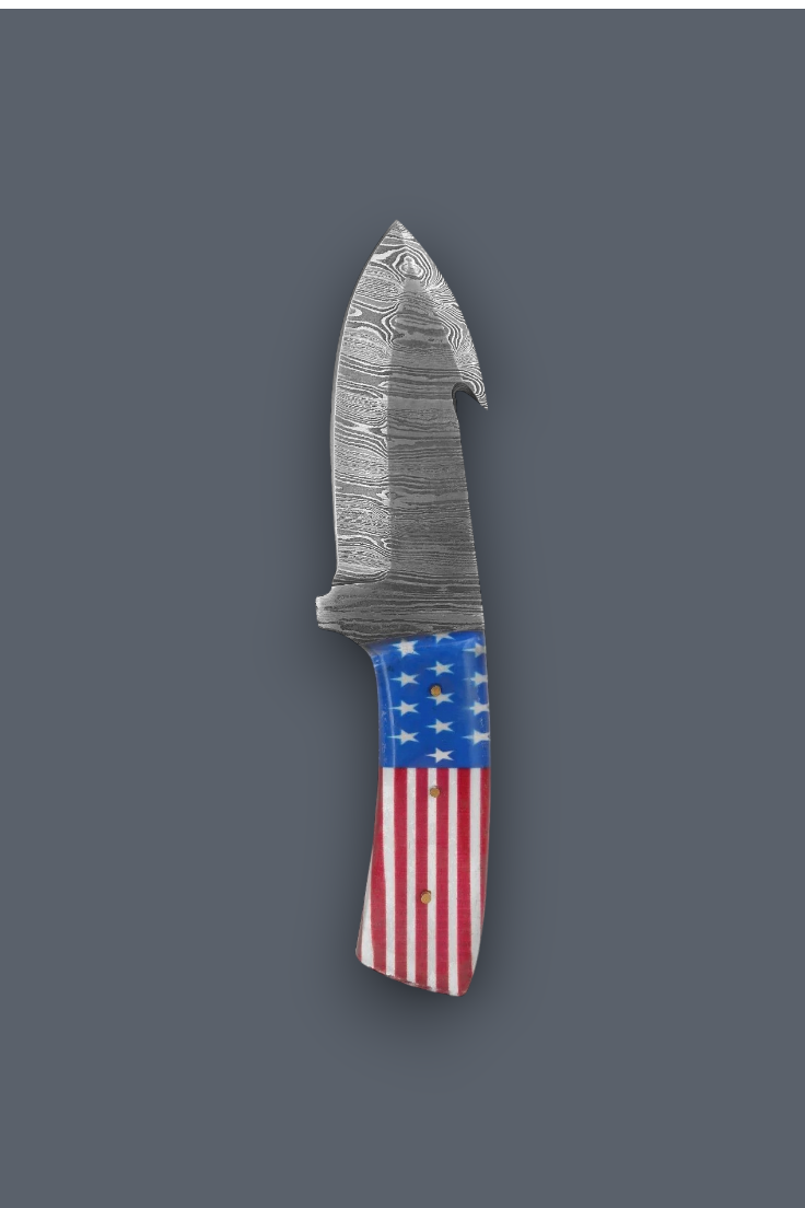 A fixed-blade knife with a patterned steel blade and a handle featuring an American flag design, shown against a solid dark gray background.