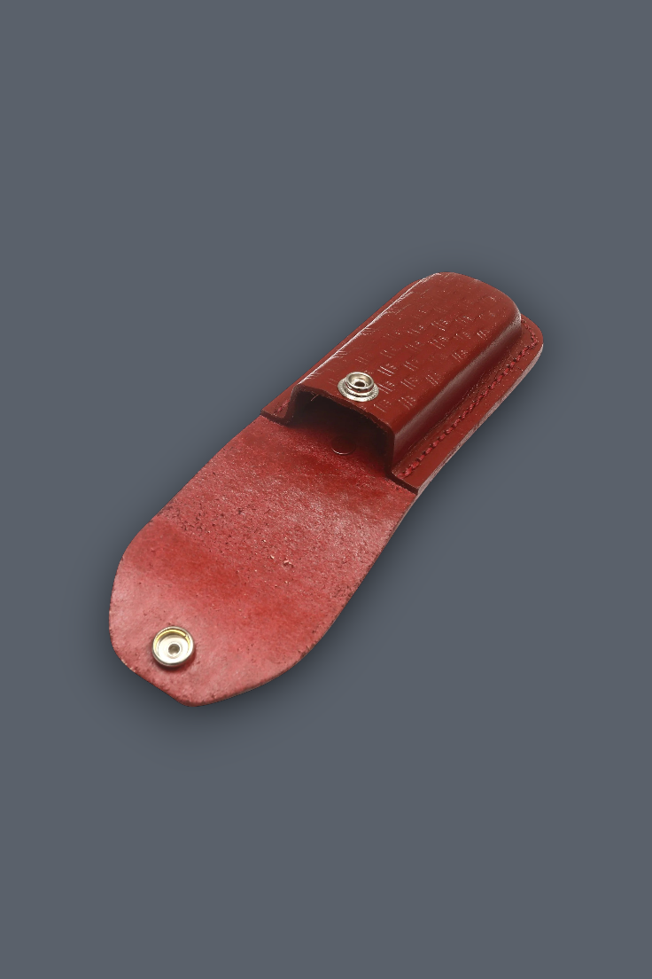 A reddish-brown leather knife sheath with a snap-button closure, shown on a solid dark gray background.