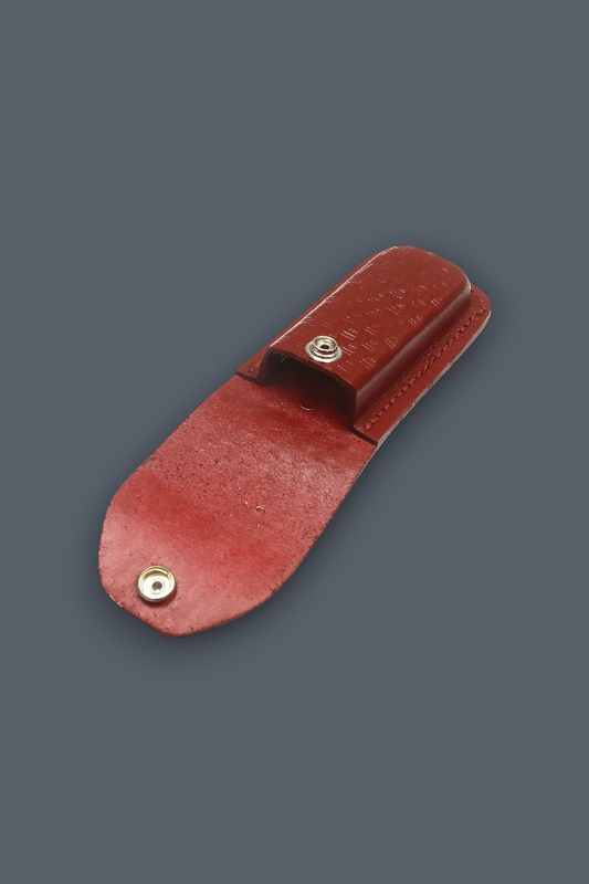 A reddish-brown leather knife sheath with a snap-button closure, shown on a solid dark gray background.