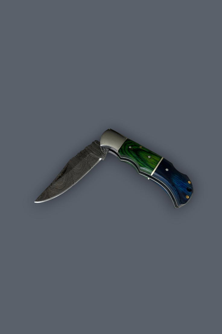 A folding pocket knife with a Damascus steel blade, a silver bolster, and a handle featuring green and blue marbled scales with brass pins, shown on a solid dark gray background.