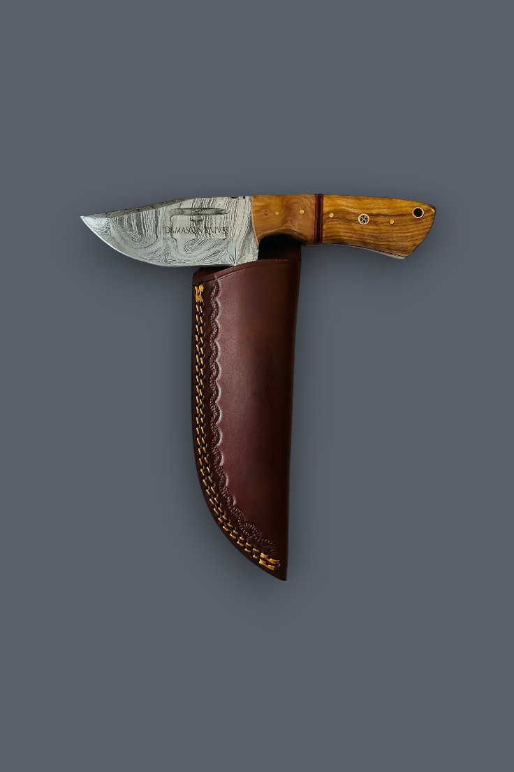 A fixed-blade knife with a patterned steel blade, a light brown wood handle, and a dark brown leather sheath, displayed against a solid dark gray background.