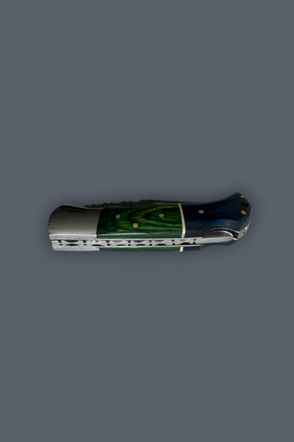 A folding pocket knife with a polished silver metal blade and handle, featuring a green and blue marbled inlay on the handle, set against a solid dark gray background.
