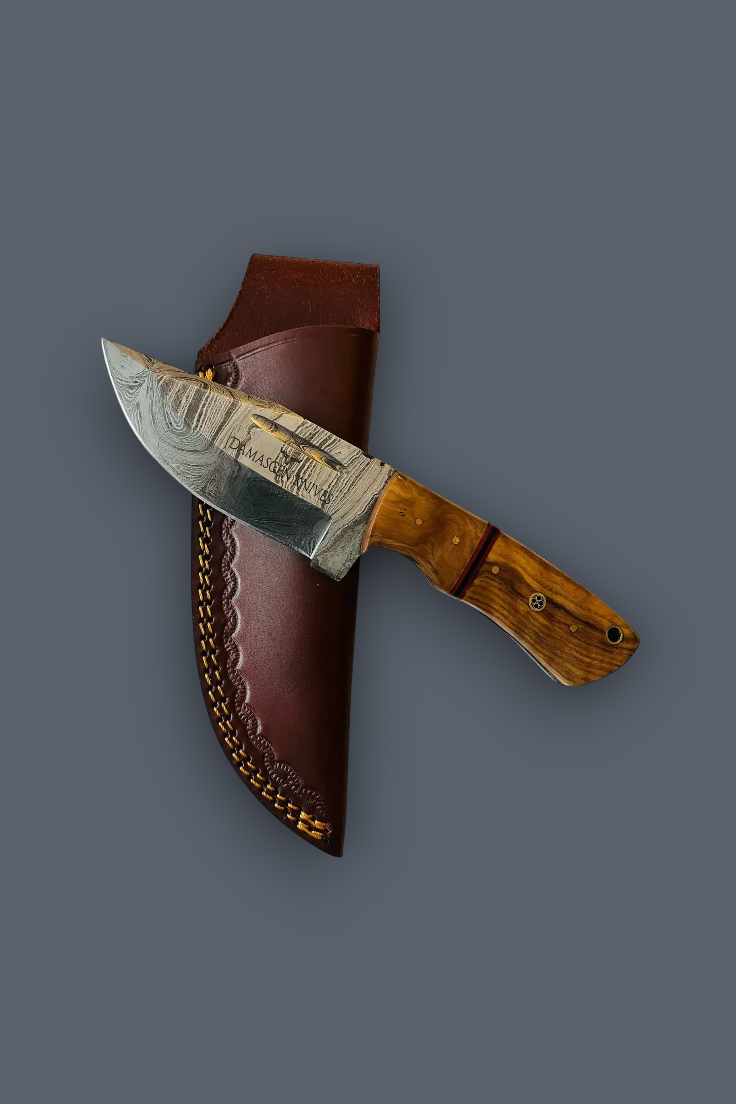 A fixed-blade knife with a patterned steel blade, a brown wooden handle, and a brown leather sheath, displayed diagonally on a solid dark gray background.
