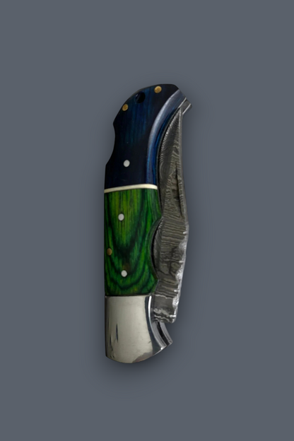 A folding pocket knife with a dark blue and green marbled wood handle, set against a solid dark gray background.