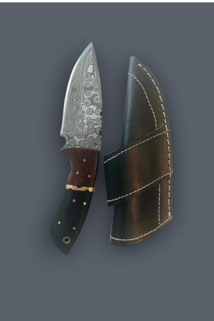 A fixed-blade knife with a patterned steel blade, brown handle, and black handle, shown next to its black leather sheath on a dark gray background.