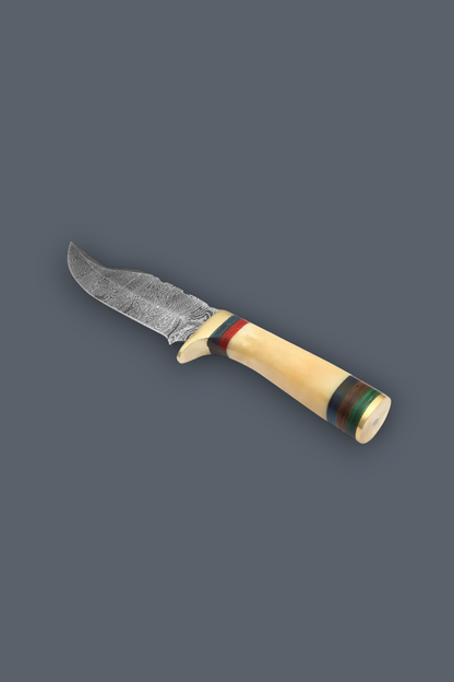 A fixed-blade knife with a textured, patterned steel blade and a curved handle made of natural bone, decorated with red, green, and blue stripes, shown on a solid dark gray background.
